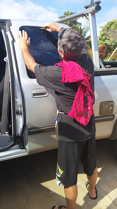 Mike's Mobile Tinting applying auto window tint to a truck in Kauai